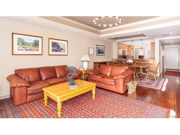 Inviting living room featuring leather seating, a wooden coffee table, and a decorative rug at 1900 E Girard Pl # 608, Englewood, CO 80113