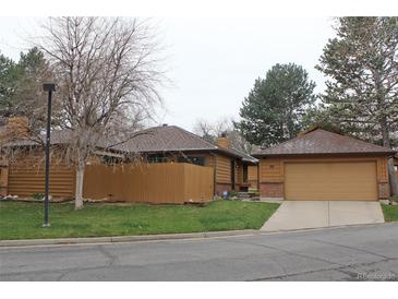 Charming exterior elevation of a home featuring a two-car garage and well-maintained landscaping at 95 S Eagle Cir, Aurora, CO 80012