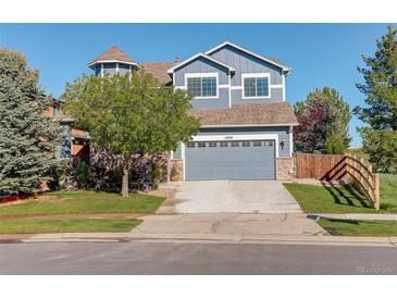Charming two-story home with a well-maintained front yard and a gray two-car garage at 1909 Alpine Dr, Erie, CO 80516