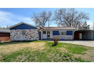 Charming single-story home featuring a brick facade, blue accents, and a well-maintained front yard at 1720 Pecos Way, Denver, CO 80221