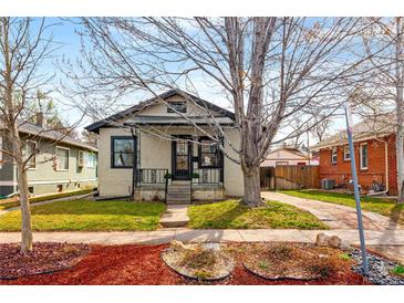 Charming home featuring a well-kept lawn, attractive landscaping, and a welcoming front porch area at 2676 S Lincoln St, Denver, CO 80210