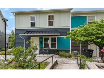 Inviting townhouse with covered porch, chairs, and colorful exterior accents at 2829 W 53Rd Ave # 104, Denver, CO 80221