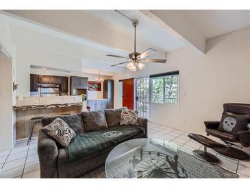 Cozy living room featuring an open floor plan, ceiling fan, and tiled floors at 384 S Ironton St # 314, Aurora, CO 80012