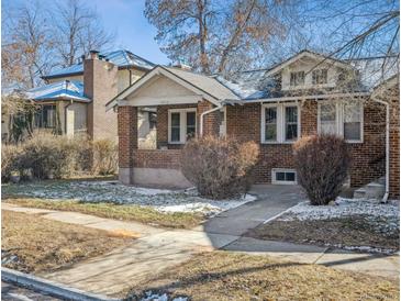 Charming brick home featuring a well-maintained front yard and inviting walkway at 4326 Batavia Pl, Denver, CO 80220