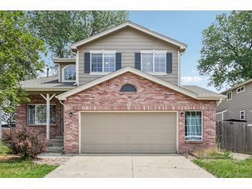 Charming two-story home with brick and siding, featuring a two-car garage and well-maintained landscaping at 1440 E 128Th Ct, Thornton, CO 80241