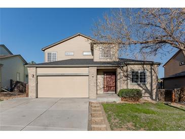 Charming two-story home featuring a two-car garage, well-maintained lawn, and mature trees at 2875 S Tower Way, Aurora, CO 80013