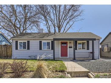 Charming single-story home featuring a red front door, neutral siding, and a well-maintained front yard at 1120 Quince St, Denver, CO 80220