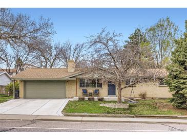 Charming brick home featuring a well-maintained yard and an attached two-car garage at 6661 Lamar St, Arvada, CO 80003