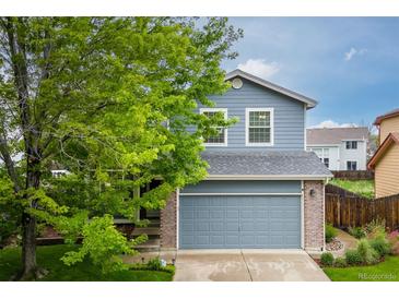 Charming two-story home with a well-maintained lawn, mature tree, and attached two-car garage at 2763 Dharma Ave, Broomfield, CO 80020