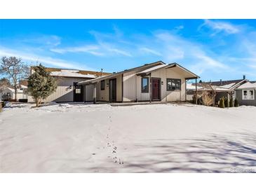 Updated ranch home exterior, featuring a snow-covered yard at 25 Irene Ct, Broomfield, CO 80020