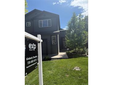 Charming two-story home featuring a well-manicured lawn and professional real estate signage at 1464 Spotted Owl Way, Highlands Ranch, CO 80129