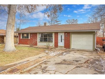 Brick ranch home with attached garage and landscaped yard at 340 S Swadley St, Lakewood, CO 80228