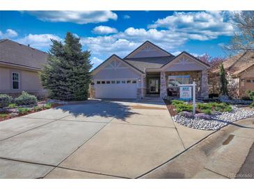 Charming single-story home with manicured landscaping, stone accents, and a spacious driveway at 6638 S Tibet Ct, Aurora, CO 80016