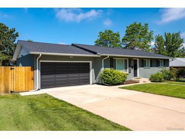 Charming single-story home boasts a well-maintained front yard and an attached two-car garage at 3461 S Ivy Way, Denver, CO 80222