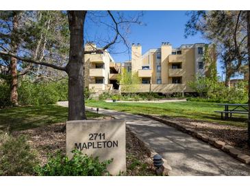 Inviting multi-unit property with lush lawn, mature trees, and prominent signage, offering a serene residential environment at 2711 Mapleton Ave # 27, Boulder, CO 80304