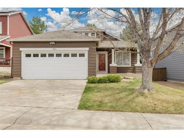 Charming single-Gathering home showcasing a two-car garage, manicured lawn and inviting curb appeal in a residential neighborhood at 5463 Rockhampton Cir, Highlands Ranch, CO 80130