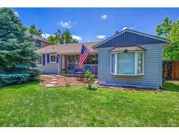 Charming home with a well-maintained lawn and garden, complete with an American flag at 3313 S Dexter St, Denver, CO 80222