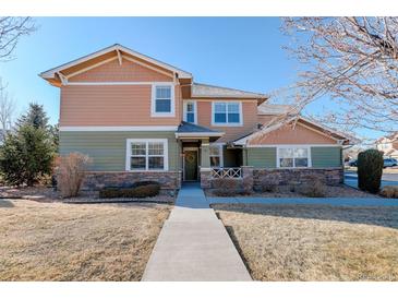 Charming two-story home featuring a mix of siding and stonework on the facade with a walkway to the front door at 3733 S Perth Cir # 101, Aurora, CO 80013