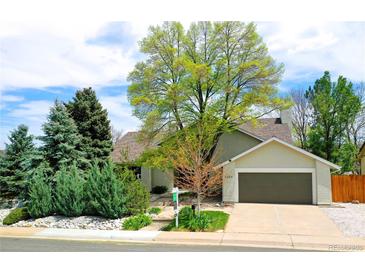 Charming single-Gathering home featuring a well-maintained front yard and an attached two-car garage at 6054 S Akron Way, Greenwood Village, CO 80111