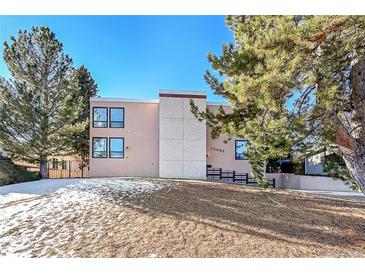 Mid-century modern building exterior, featuring a clean design and landscaping at 13682 W Virginia Dr, Lakewood, CO 80228