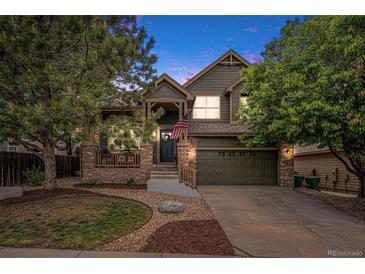 Charming two-story home with landscaped yard and covered porch at 11681 Night Heron Dr, Parker, CO 80134
