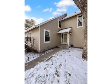Charming townhome featuring a quaint front entrance and walkway lined with landscape lighting at 2639 S Xanadu Way # B, Aurora, CO 80014