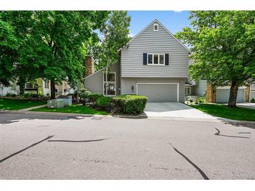 Charming two-story home with a gray exterior, well-manicured landscaping, and an attached two-car garage at 4505 S Yosemite St # 125, Denver, CO 80237