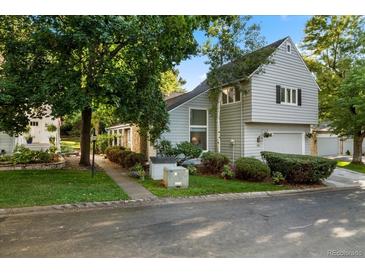 Inviting gray two-story home with charming landscaping and a well-maintained front yard at 4505 S Yosemite St # 125, Denver, CO 80237