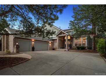 Charming home featuring a three-car garage, brick facade, and well-manicured landscaping at 2187 Wynterbrook Dr, Highlands Ranch, CO 80126