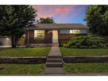 Charming brick home featuring a well-manicured lawn and inviting front porch at 1760 W 74Th Way, Denver, CO 80221