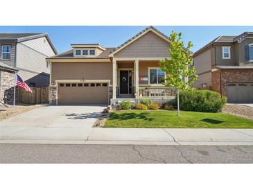 Charming single-Gathering home with a well-manicured lawn, a covered porch, and an attached two-car garage at 5425 E 125Th Pl, Thornton, CO 80241