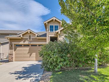 Inviting two-story home with a neatly trimmed lawn and a two car garage under a partly cloudy sky at 16658 Prospect Ln, Broomfield, CO 80023