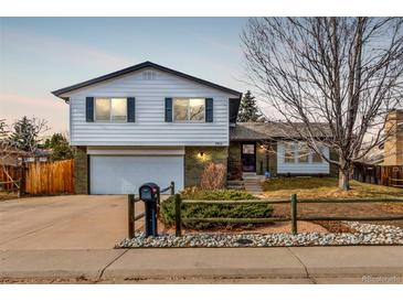 Charming split-level home with well-maintained lawn and inviting curb appeal at 3411 S Olathe Way, Aurora, CO 80013