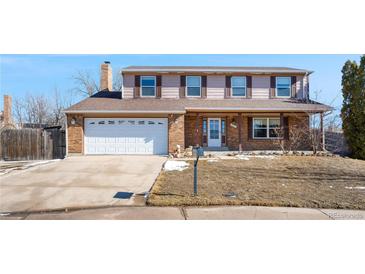 Charming two-story home with brick facade and a spacious two-car garage, perfect for Gathering living at 1456 S Jasper St, Aurora, CO 80017