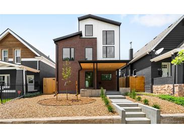 Inviting modern two-story home featuring a striking brick facade, black trim, and manicured front yard at 4131 Osage St, Denver, CO 80211