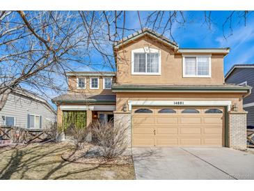 Charming two-story home with an attached two car garage at 14881 E 117Th Ave, Commerce City, CO 80603
