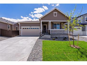 Charming single-Gathering home with a well-manicured lawn and inviting front porch at 19040 E 96Th Pl, Commerce City, CO 80022