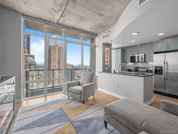 Open-concept living room with floor-to-ceiling windows and a modern kitchen at 891 14Th St # 2505, Denver, CO 80202