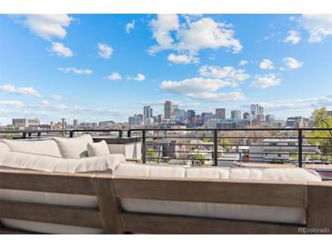Stunning city views from the rooftop deck with comfortable seating area, perfect for outdoor relaxation and entertainment at 3820 Jason St # 3, Denver, CO 80211