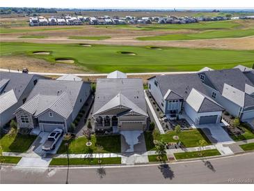 Aerial view of a house and neighborhood with golf course views at 3214 Heron Lakes Pkwy, Berthoud, CO 80513