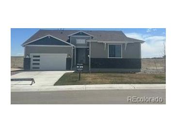 Charming home with modern garage door and gray accents, situated on a bright lot at 42978 Colonial Trl, Elizabeth, CO 80107