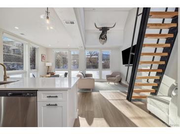 Modern kitchen with stainless steel appliances and white cabinetry at 1401 Jackson St # 204, Golden, CO 80401