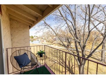 Relax on the balcony with views of mature trees and lake with bridge at 12114 Melody Dr # 303, Denver, CO 80234