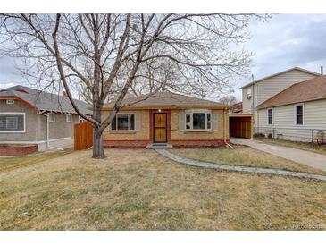 Brick ranch home with landscaped yard and attached carport at 4324 Eaton St, Denver, CO 80212