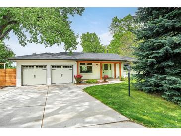 Charming single-story home with a well-manicured lawn, two-car garage, and appealing curb appeal at 6891 W Eldorado Pl, Lakewood, CO 80227
