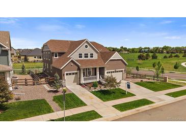 A beautiful two-story home with a three-car garage, landscaped yard and a charming front porch at 848 Sandstone Cir, Erie, CO 80516