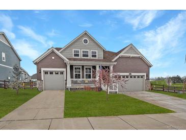 Charming two-story home featuring a manicured lawn and two-car garages, perfect for families at 848 Sandstone Cir, Erie, CO 80516