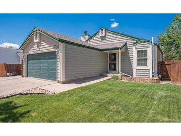 Charming single-Gathering home featuring a well-manicured lawn and a two-car garage at 11337 E 1St Ave, Aurora, CO 80010