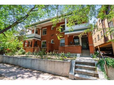Charming brick townhouse featuring a well-manicured front garden, a classic facade, and a welcoming entrance at 1243 N Lafayette St, Denver, CO 80218