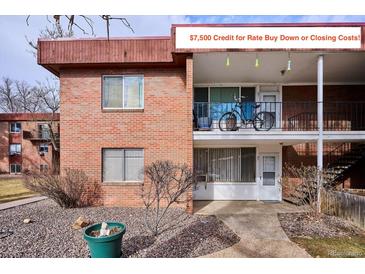 Charming brick two-story condo with a cozy balcony and a well-maintained landscape at 10125 W 25Th Ave # 47, Lakewood, CO 80215